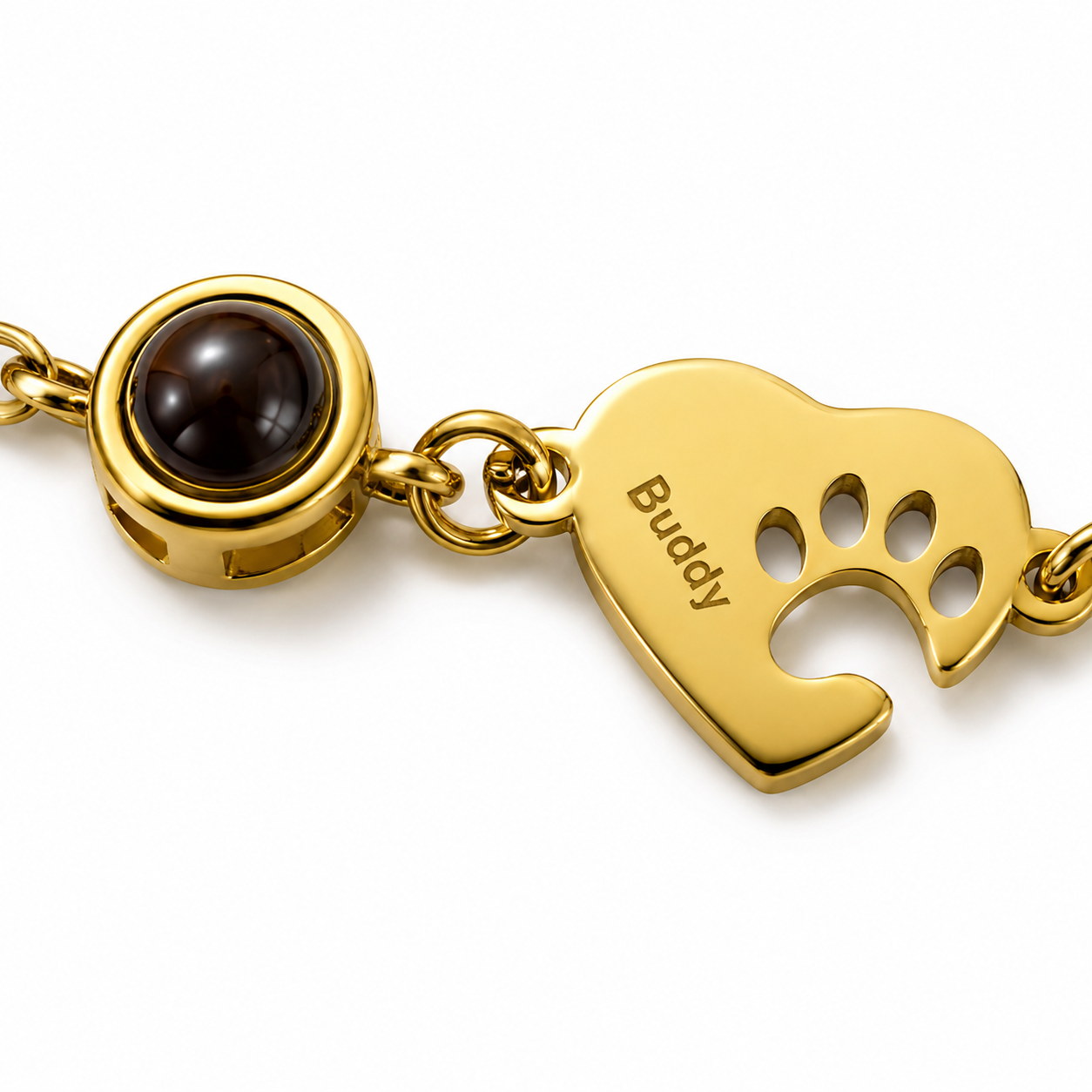 Gold Paw Heart Birthstone Bracelet close-up with dark birthstone and Buddy charm